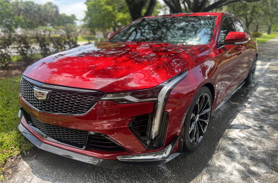 Stunning red Cadillac sedan captured by Broward Detailers, showcasing premium car detailing services in South Florida.