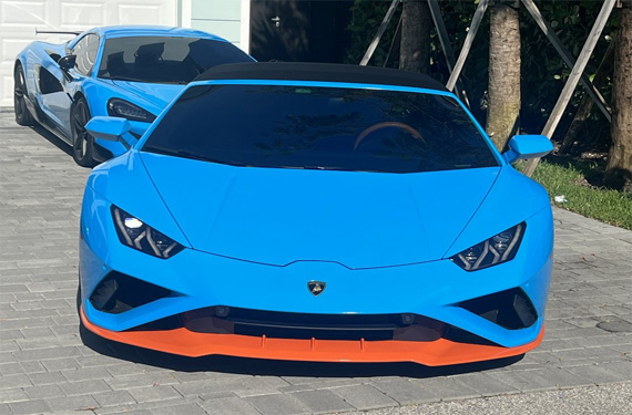 Striking blue Lamborghini with orange accents, highlighted by Broward Detailers' expert car detailing services in South Florida.