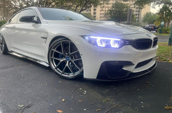 Stylish white BMW 4 Series with custom wheels and enhanced lighting, showcasing premium detailing by Broward Detailers in South Florida.