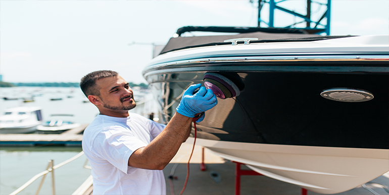 Broward Detailers' professional technician performing boat detailing on a sleek vessel in South Florida.