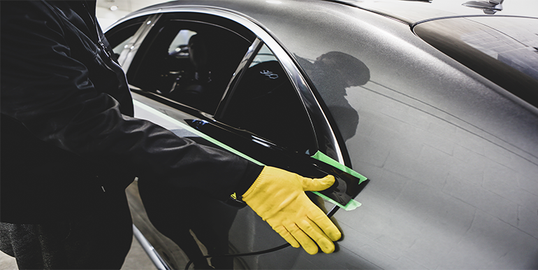 Professional chrome delete service being performed on a vehicle in South Florida, enhancing its sleek appearance by removing chrome accents.