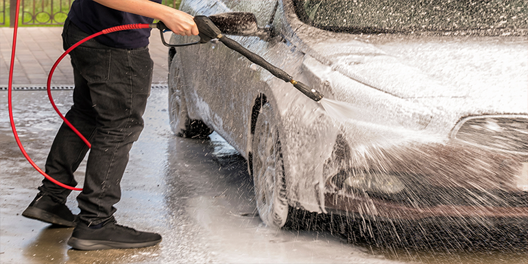 Professional mobile car wash service in South Florida, showcasing high-pressure foam washing for a sparkling clean vehicle.