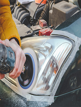 Professional headlight restoration service in South Florida, demonstrating a technician using a polishing tool to enhance headlight clarity and visibility.