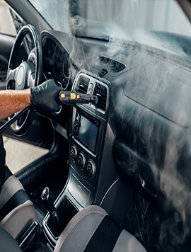 Professional steam cleaning service in South Florida, showcasing a technician using steam to sanitize and deep clean the interior of a vehicle for optimal hygiene and freshness.