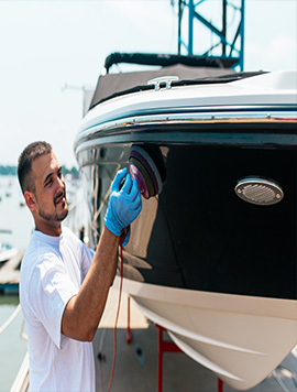 Broward Detailers technician expertly polishing a boat during a detailing service in South Florida.