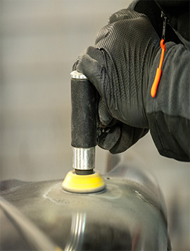 Broward Detailers technician utilizing a polishing tool for professional scratch removal in South Florida, enhancing vehicle appearance and restoring paint quality.